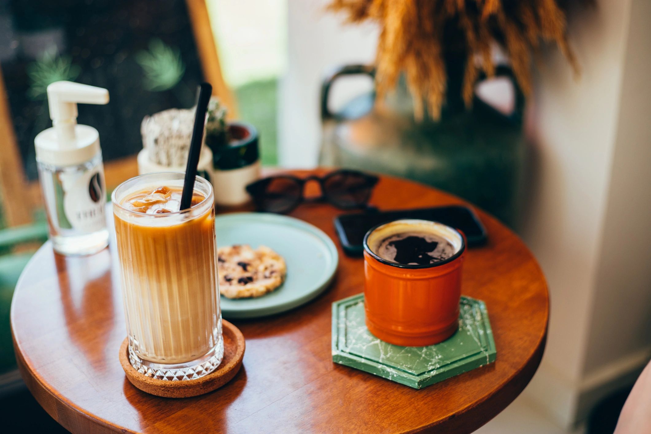 Iced latte and cookie on a coffee table