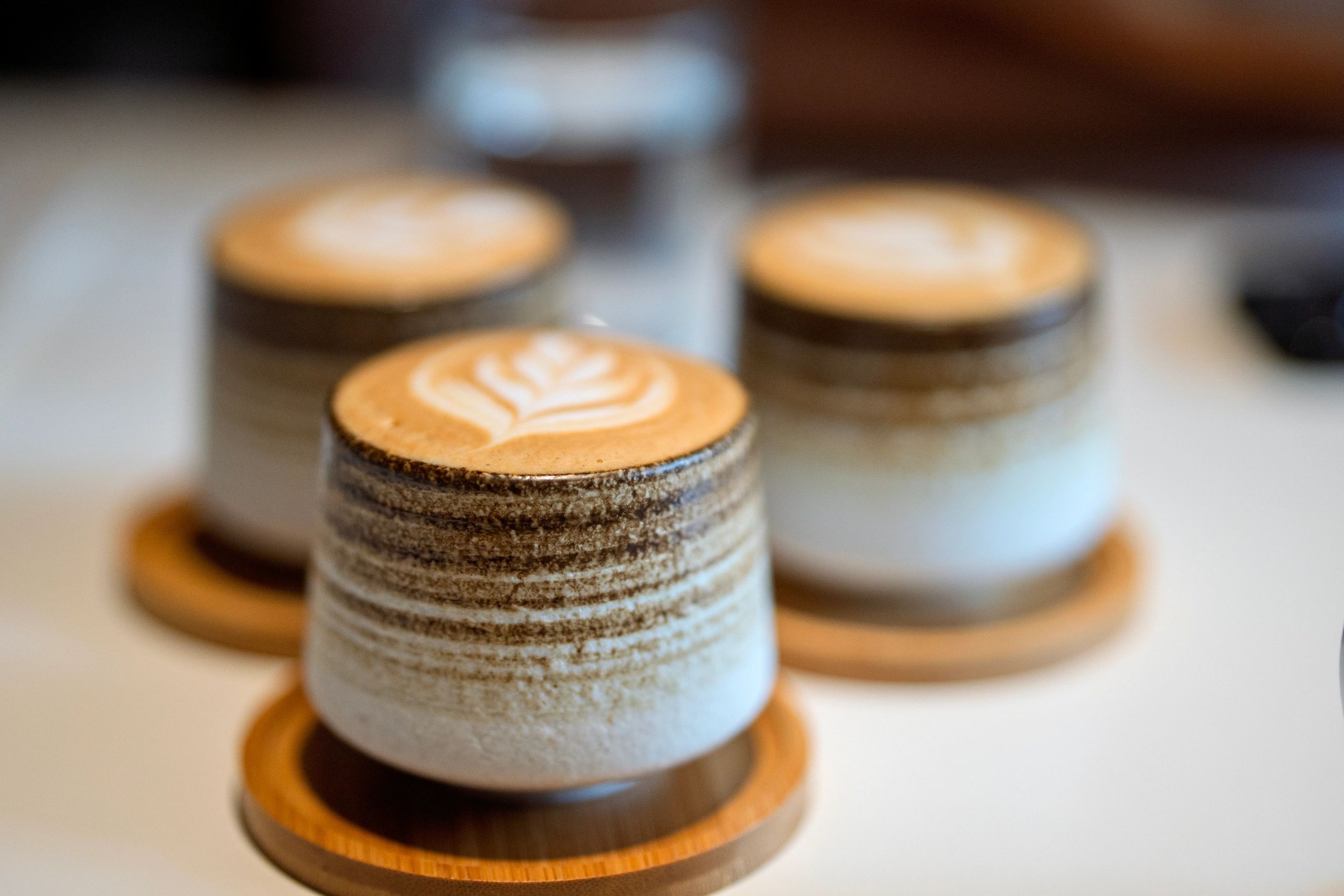 Artisan lattes with latte art in ceramic cups