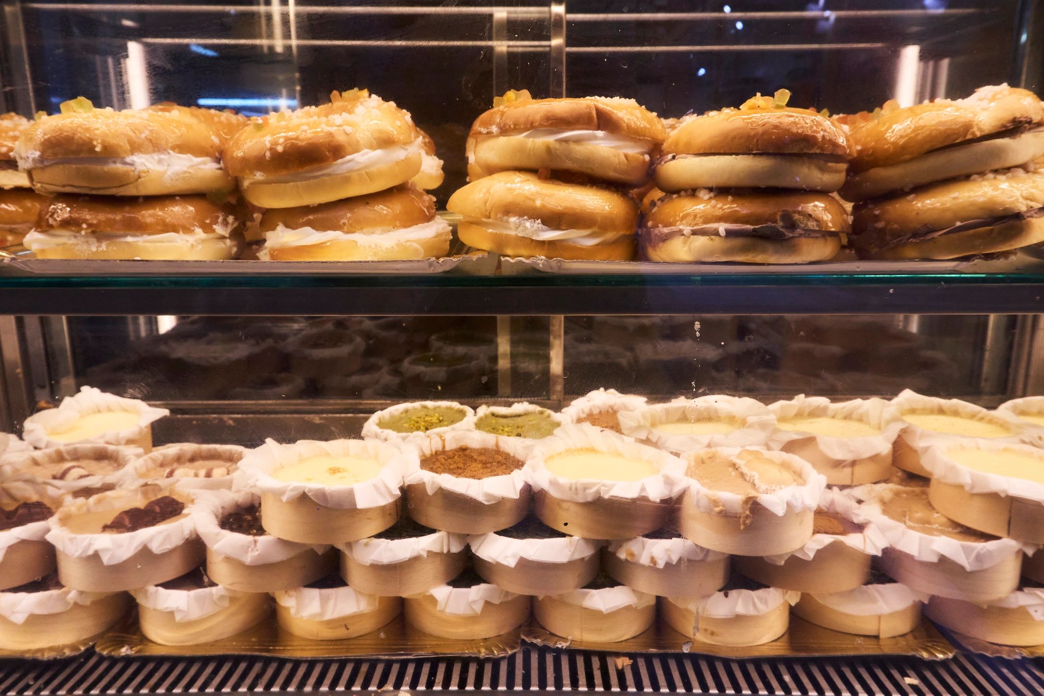 Pastries displayed in a warmly lit cafe case